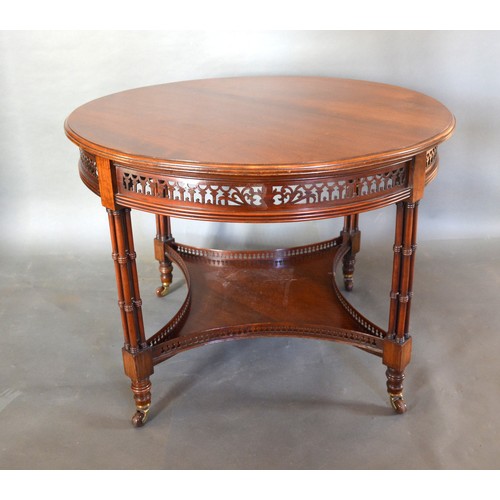 422 - A Walnut Circular Centre Table, the moulded top above a pierced frieze and raised upon four quadrupl... 