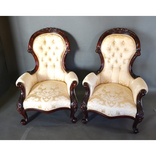 423 - A Pair Of Victorian Style Drawing Room Armchairs, each with a carved and button upholstered back abo... 