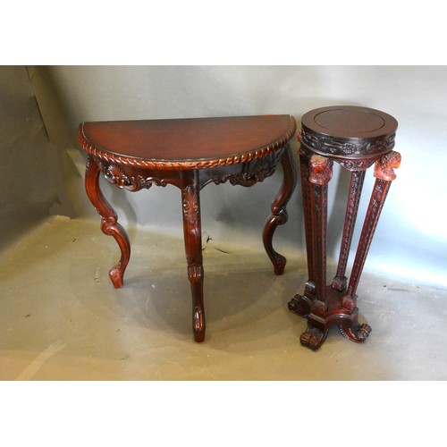 428 - A Mahogany Demi-Lune Console Table with a moulded top above a carved pierced frieze, raised upon cab... 