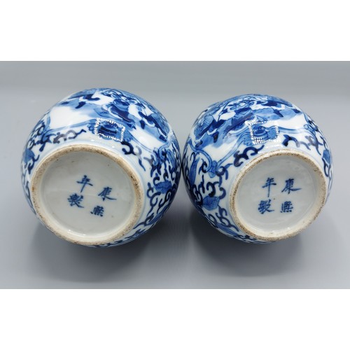 1 - A pair of Chinese porcelain double gourd vases, each decorated in underglaze blue and with four char... 