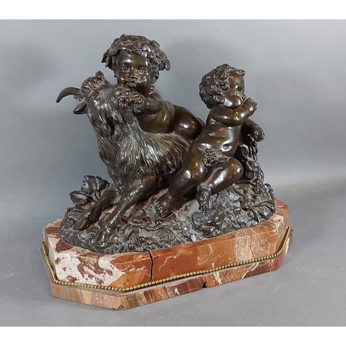 293 - A French patinated bronze group in the form of two Putti with a goat upon rouge marble base, 35cms w... 