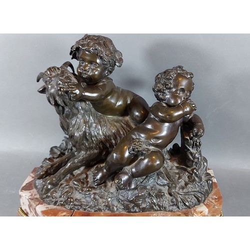 293 - A French patinated bronze group in the form of two Putti with a goat upon rouge marble base, 35cms w... 