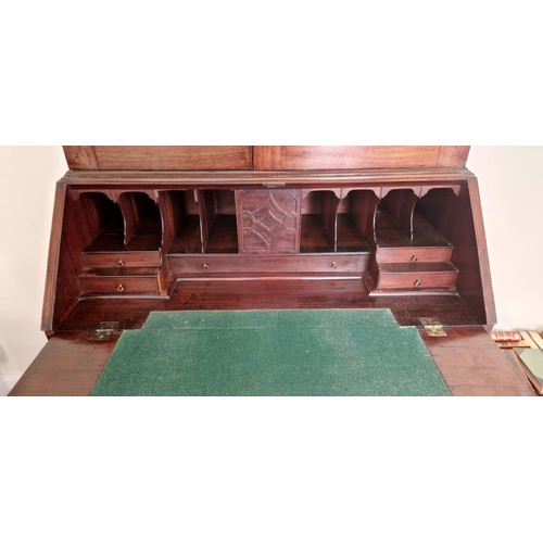 413 - A George III mahogany bureau bookcase, the moulded cornice above two arched glazed doors enclosing s... 