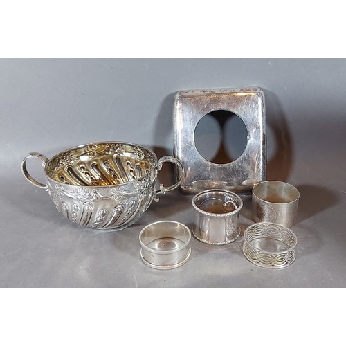 168 - A Sheffield silver two handled sucrier together with a London silver clock frame and four silver nap... 