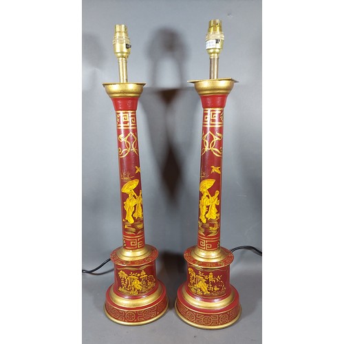 311 - A pair of toleware table lamps each with Chinoiserie decoration on a red ground, 60cms tall