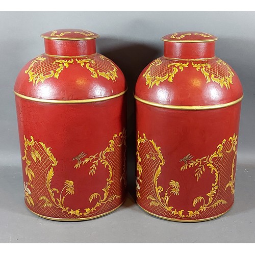 312 - A pair of Toleware covered cannisters each with Chinoiseie decoration in gilt, 35cms tall