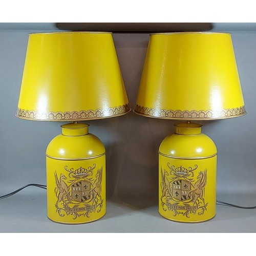 315 - A pair of Toleware table lamps each decorated with an Armorial crest upon a mustard ground with Tole... 