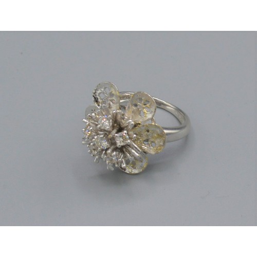 231 - An 18ct white gold diamond cluster ring, set with six diamonds within a pierced setting, 9.1 grams, ... 