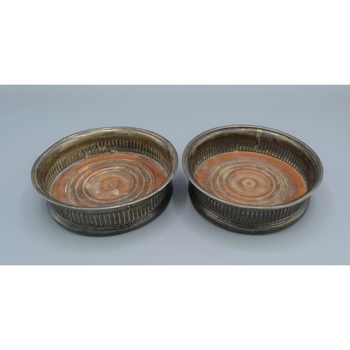 244 - A pair of Georgian silver bottle coasters of lobed form, 14cms diameter