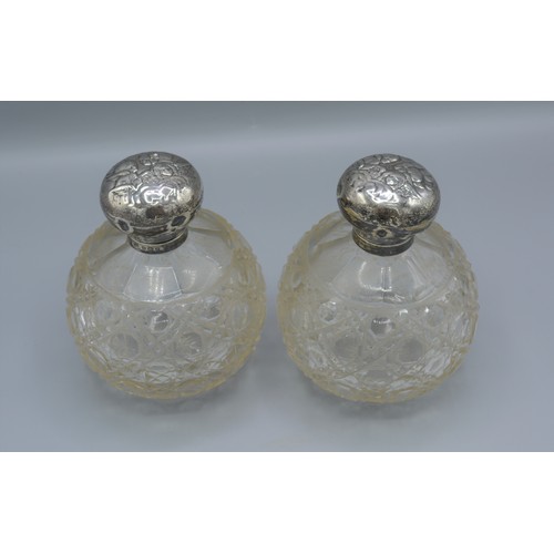 257 - A pair of Edwardian silver and cut glass large scent bottles, decorated with whispers, Birmingham 19... 