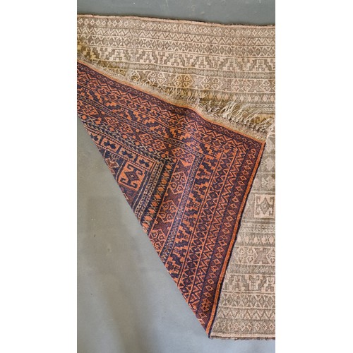 385 - An Afghan woollen rug with an all-over design upon a pale ground within multiple borders, 150cms x 9... 