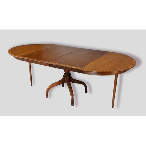467 - A mahogany extending dining table, the crossbanded top above a turned centre column raised upon four... 