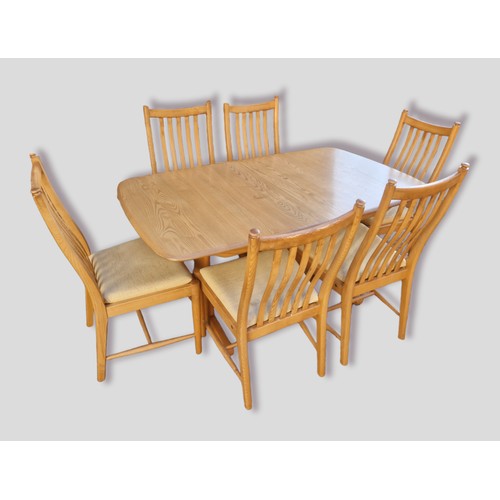 348 - An Ercol Winsdor extending dining table, 203cms x 92cms fully extended together with six matching Pe... 