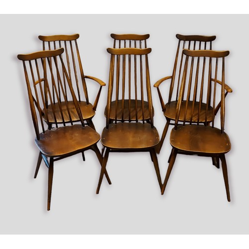 352 - A set of six Ercol stick back dining chairs comprising two armchairs and four single chairs