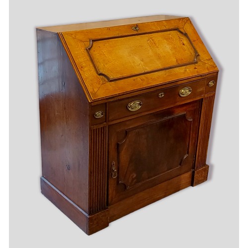 354 - An oak bureau, the fall front enclosing a fitted interior above a frieze drawer and cupboard door ra... 