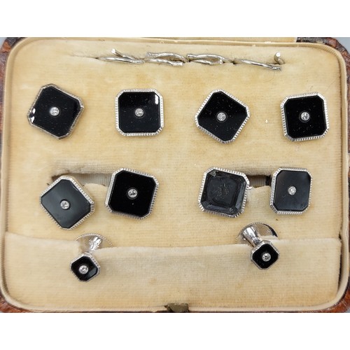 110 - A 9ct white gold black enamel and diamond cufflink and dress stud set within fitted case