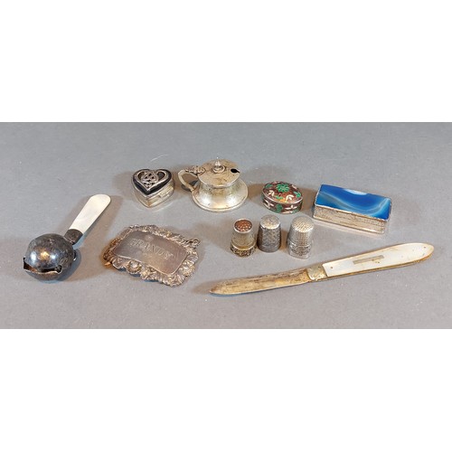 130 - Three 925 silver pill boxes together with a silver mustard, three thimbles, a silver decanter label,... 