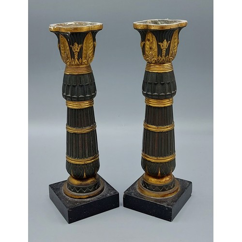 247 - A pair of French patinated bronze candlesticks with square slate bases, 22cms tall