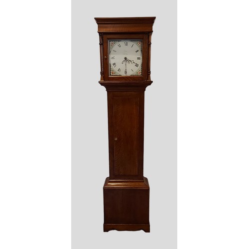 324 - A George III oak longcase clock, the square hood with turned uprights above a rectangular door, the ... 