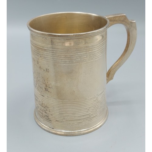 147 - A Victorian silver mug with shaped handle, London 1864, 9ozs