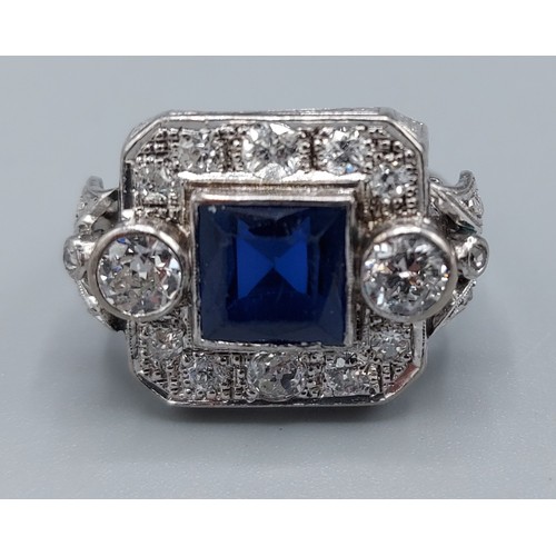 148 - A white metal Synthetic Sapphire and diamond cluster ring set with a central square synthetic Sapphi... 