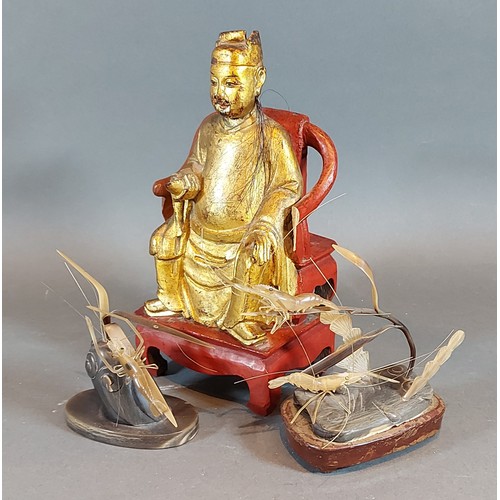 262 - A Chinese carved gilt wood model of a seated man, together with two horn models of insects