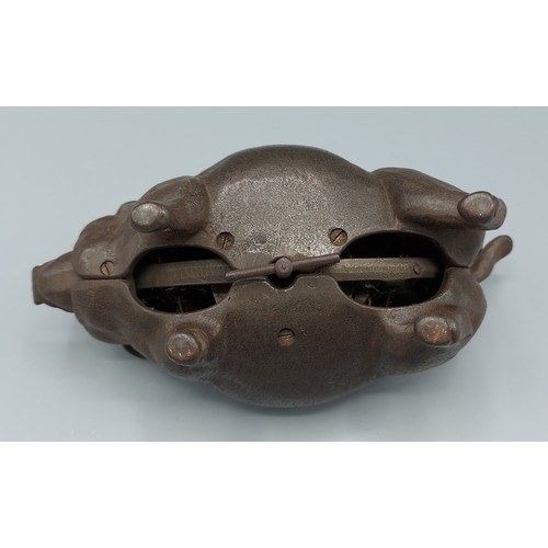 269 - A cast iron clockwork desk bell in the form of a pig 17cm long