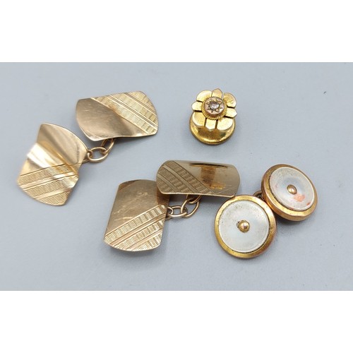 151 - A pair of 9ct gold cufflinks, 3.2gms, together with  a 9ct gold and mother of pearl cufflink and a d... 