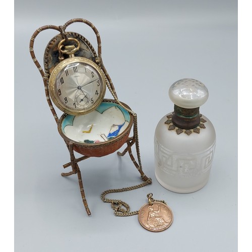 272 - A Victorian brass pocket watch stand, together with a Noxil pocket watch with chain and a glass scen... 