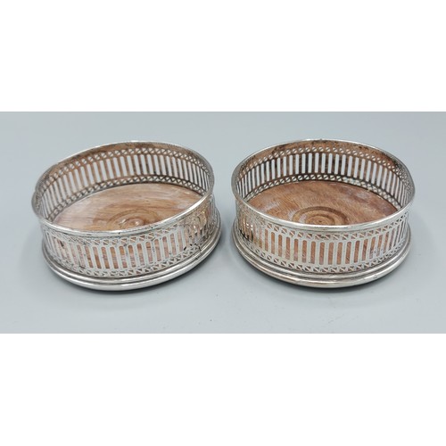 156 - A pair of London silver bottle coasters of pierced form, 9.5cms diameter