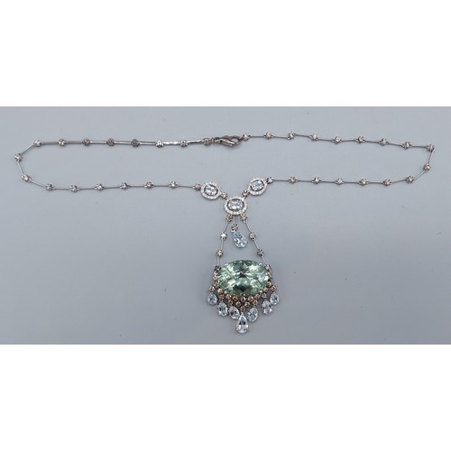 160 - An 18ct white gold Diamond and Aquamarine necklace, the large oval stone with seven drops with diamo... 