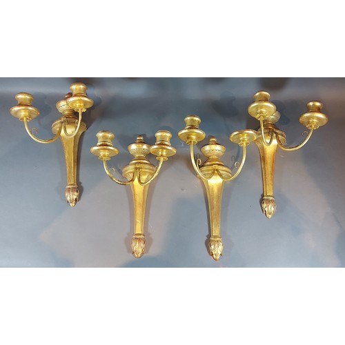 274 - A set of four gilded two branch candle wall lights, 35cms long