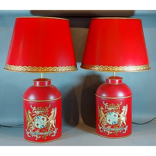 276 - A pair of Toleware table lamps, each with gilded decoration on a red ground, complete with Toleware ... 