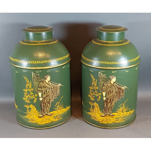 277 - A pair of Toleware covered cannisters, each gilded with figures upon a green ground, 36cms tall