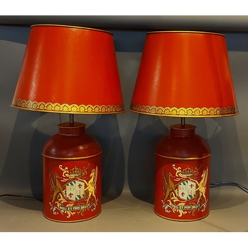 278 - A pair of Toleware table lamps, each decorated with a crest upon a red ground together with Toleware... 