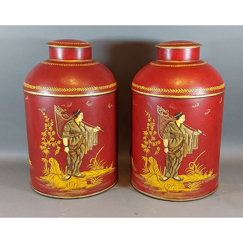 279 - A pair Toleware cannisters, each with gilded decoration depicting figures upon a red ground, 36cms t... 