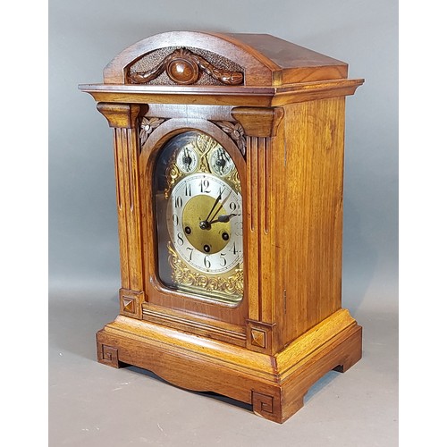 326 - An Edwardian walnut mantle clock with a brass dial, silvered chapter ring with Arabic numerals and t... 