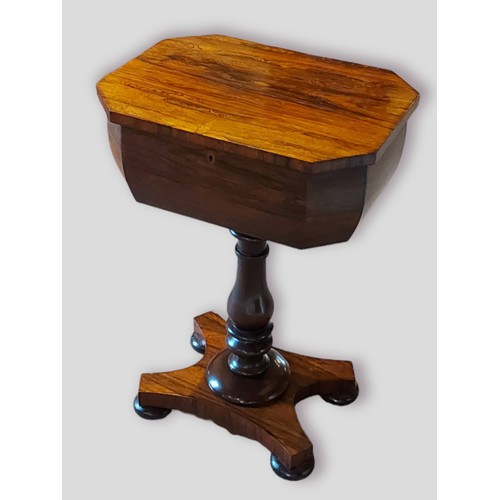 373 - A Victorian rosewood teapoy, the hinged top enclosing a fitted interior, raised upon a turned centre... 