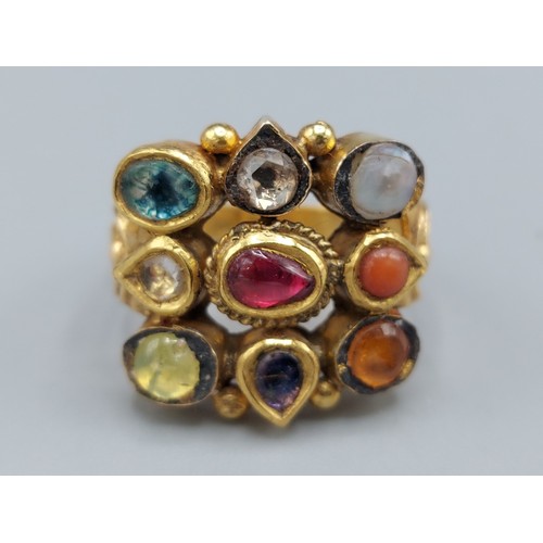 173 - A Mughal yellow metal ring set with a single diamond and semi-precious stones, 10gms,