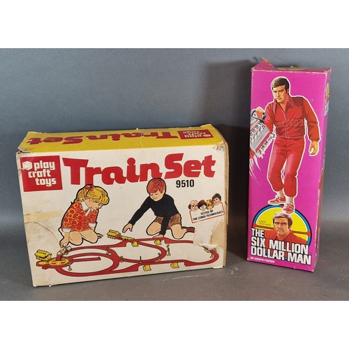 298 - The Six Million Dollar Man within original box together with a Play Craft Toys Train Set 9510 within... 