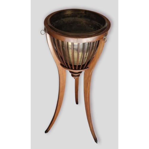 375 - A Mahogany jardiniere stand with brass liner upon three outswept legs, 85cms tall