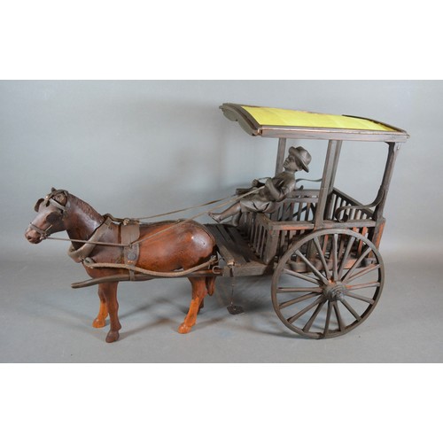 314 - A wooden model in the form of a horse and cart with figure, 52cms long