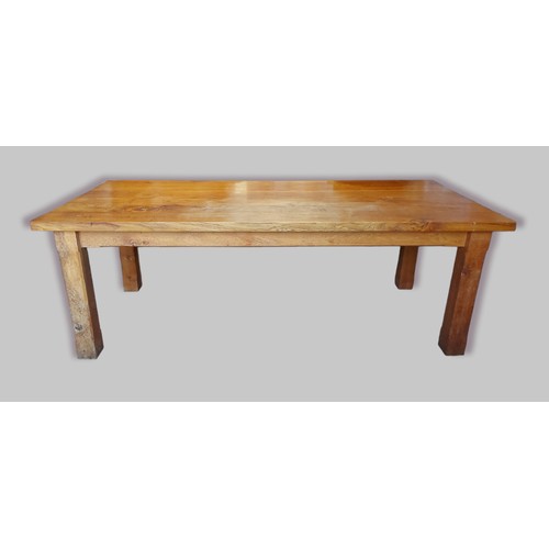 379 - A large oak French style farmhouse refectory table,the plank top above a plain frieze raised upon sq... 