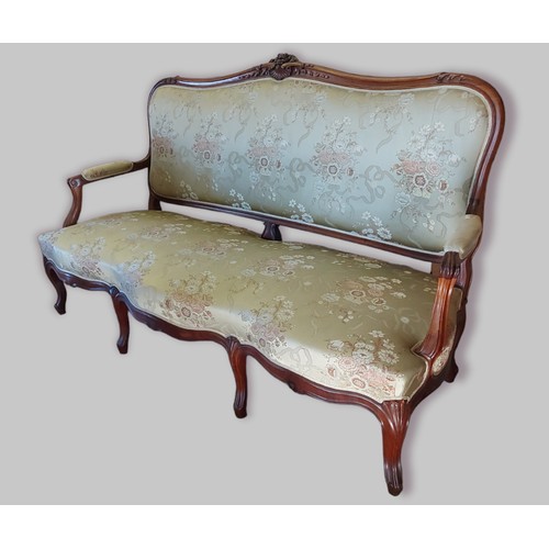 380 - A French rosewood sofa, the shaped carved and upholstered back above a similar seat with carved scro... 