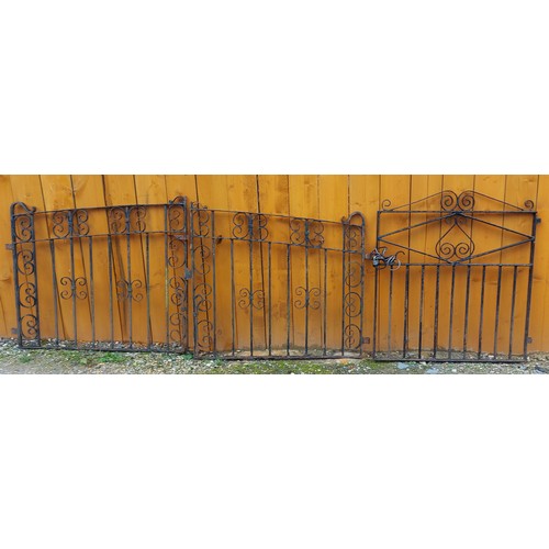 382 - A pair of iron gates of scroll form, 105cms tall, both gates together 235cms wide together with anot... 