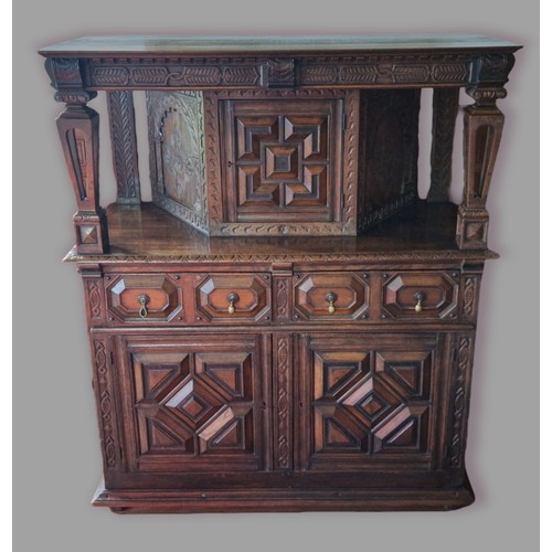 388 - An oak Court Cupboard, the top with a central moulded door flanked by pierced column, the lower sect... 