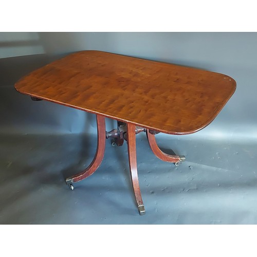 394 - A 19th Century mahogany breakfast table, the tilt top above outswept legs with brass caps and caster... 