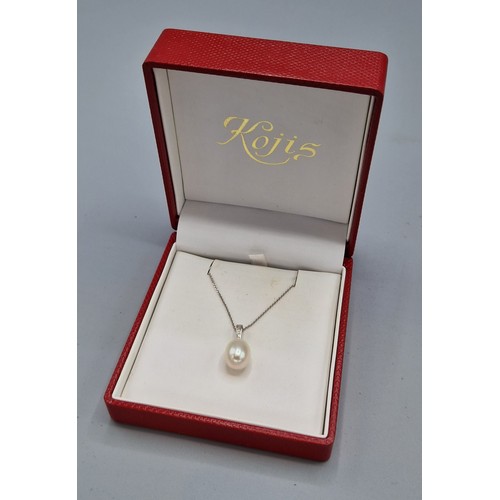 212 - An 18ct white gold pearl and diamond pendant set with three diamonds above a large pear shaped pearl... 