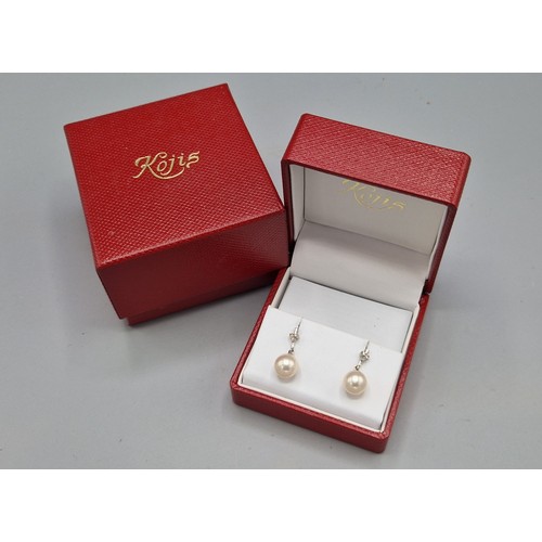 213 - A pair of 18ct white gold pearl and diamond set ear studs