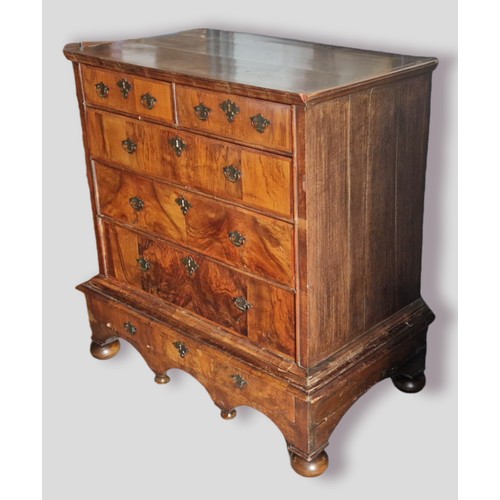 398 - An 18th Century walnut chest on stand, the moulded top above two short and three long drawers with b... 